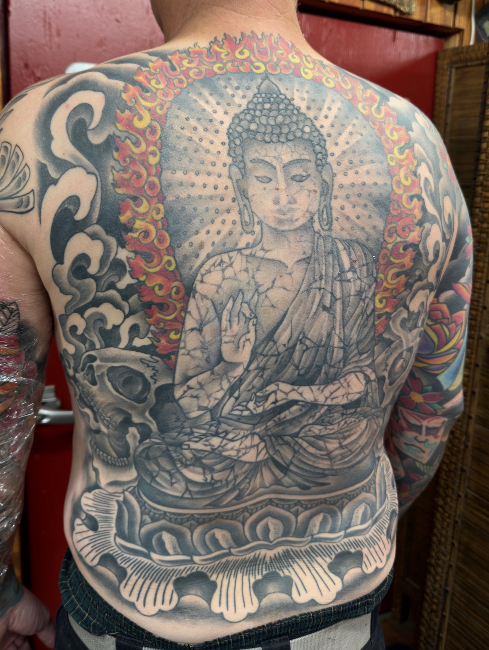  Buddha with skulls tattoo 