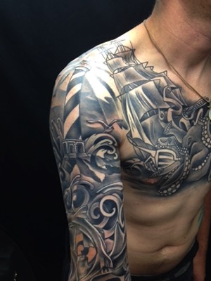  Black & gray lighthouse, ocean, ship & octopus. Tattooing by Brandon G Notch 